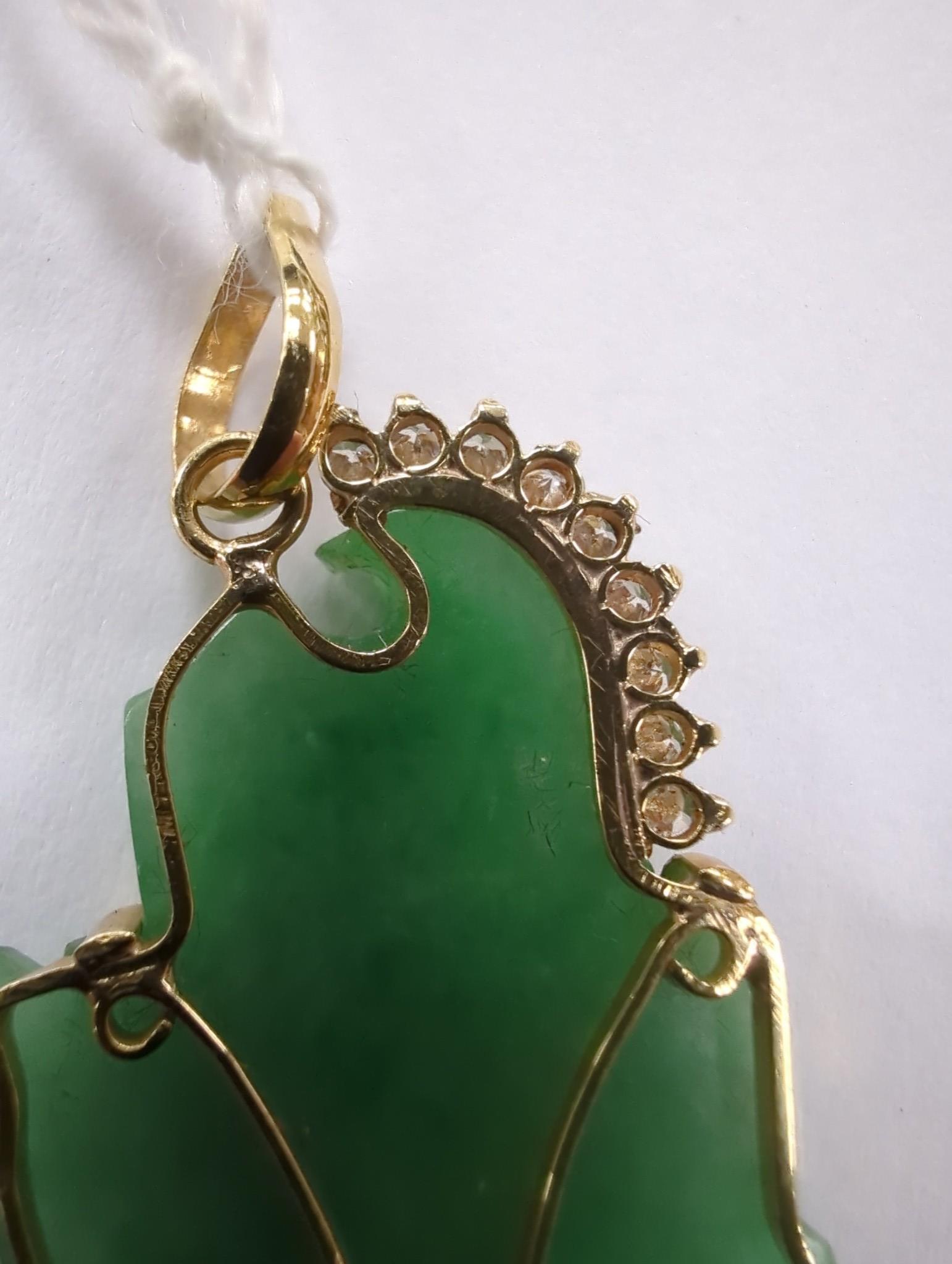 A modern 18k and diamond chip mounted jadeite pendant, carved as an immortal, 40mm, gross weight 9.1 grams.